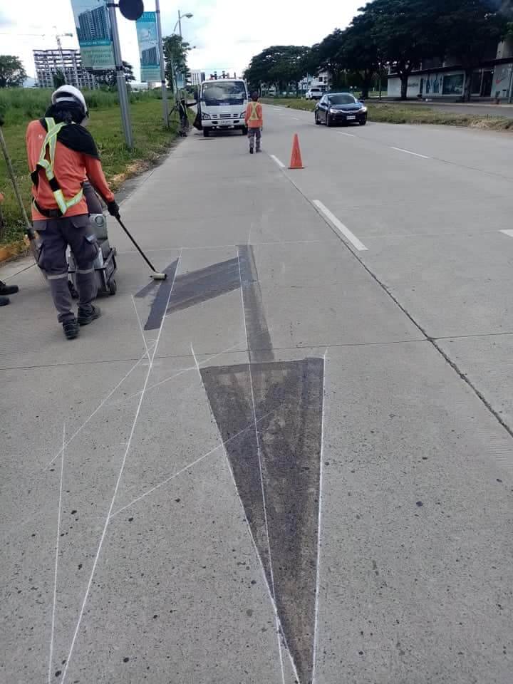 Road contractor putting on road marking primer on road