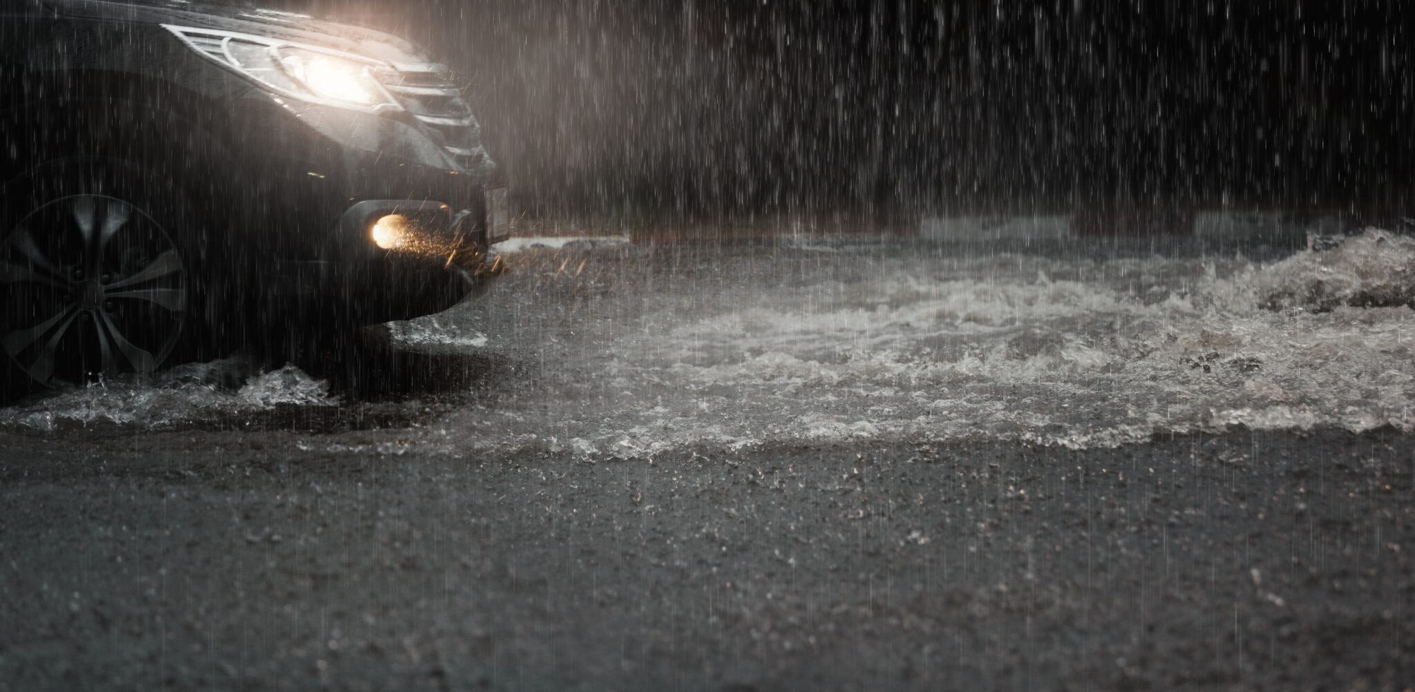 a car moving through shallow flood