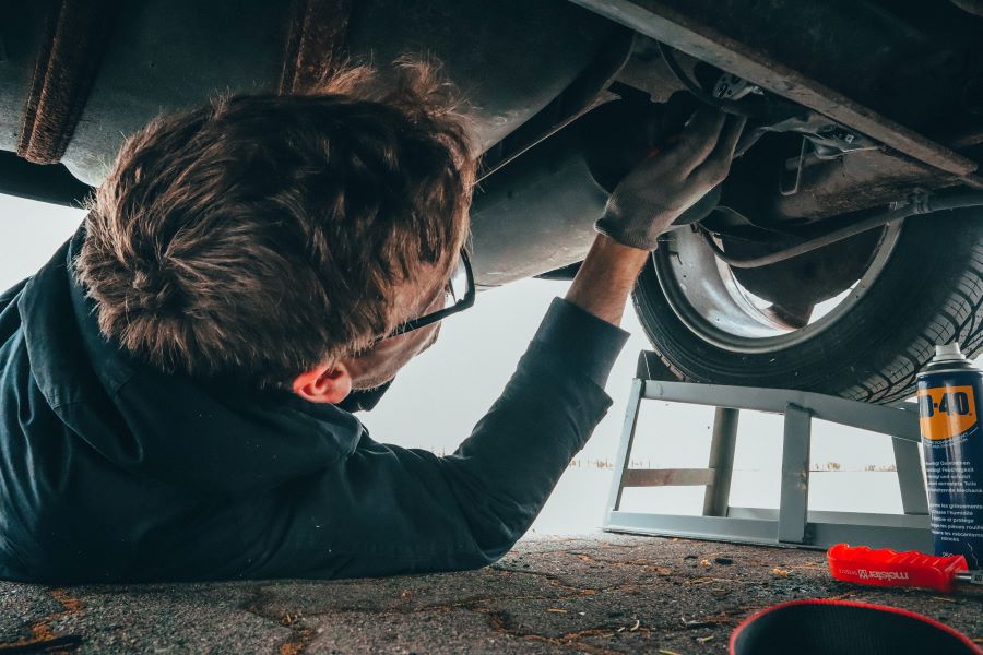 man repairing a vehicle