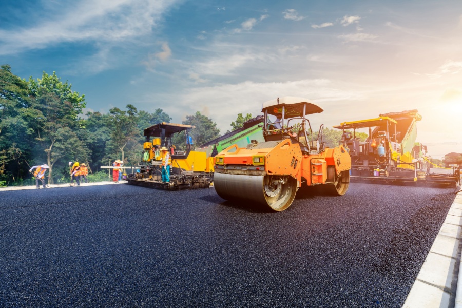 road construction vehicles putting asphalt on the road