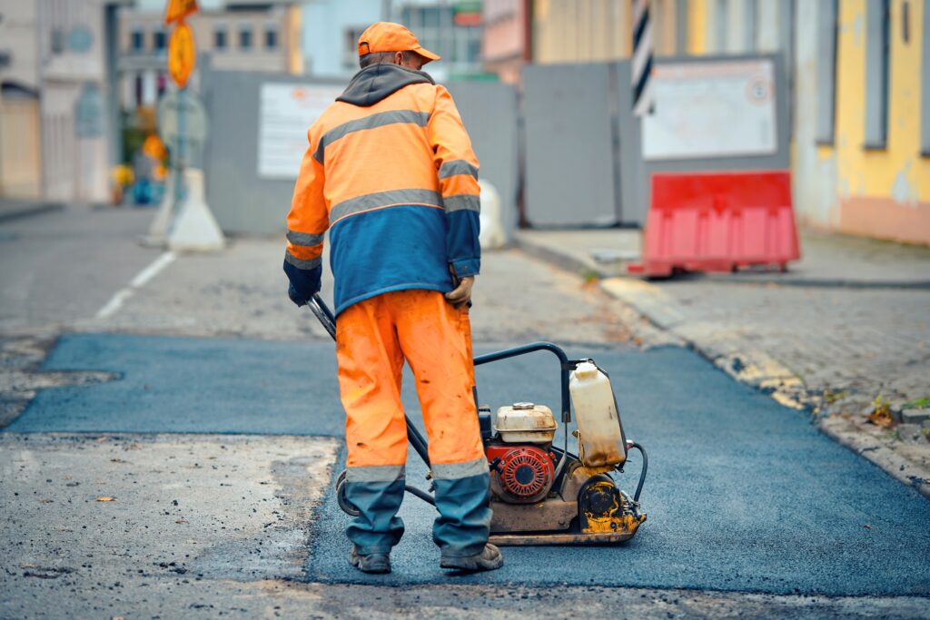 a safety road officer applying bitumen