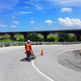 Contractor applying white road paint